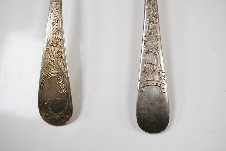A pair of George III silver gilt Old English pattern berry spoons, London, 1787, 21.8cm, two other earlier silver berry spoons and an Edwardian serving spoon by William Hutton & Sons, London, 1901, 9oz.